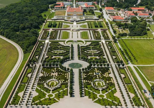 Sky view of a large outdoor garden leasing to a large building complex