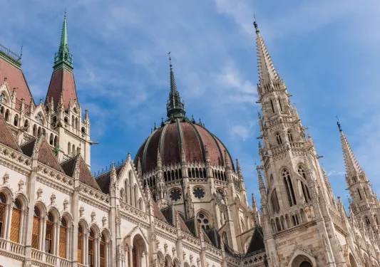 Castle-like cathedral building with clouds in the blue sky