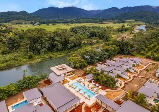 Sky view of hotel buildings with a river in the middle of a large valley