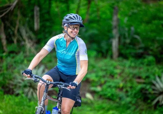 Woman wearing a Backroads jersey while riding a bike