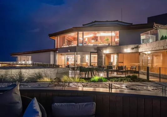 Nighttime exterior view illuminated building with large windows