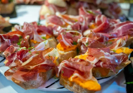 Cured meat on slices of toast