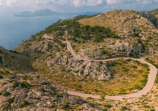 Long, sharp-turned road on an open valley