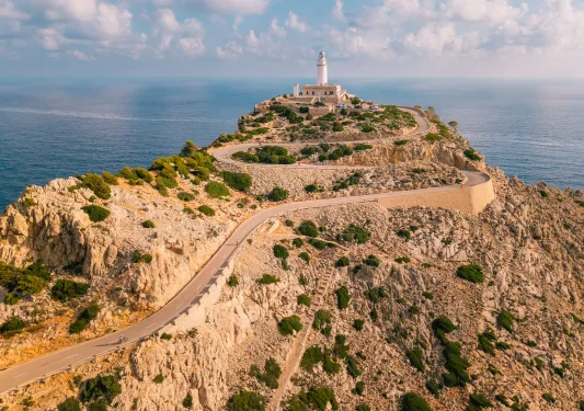 Long road along a cliff, leading to a lighthouse