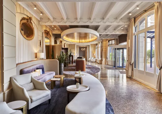 Hotel lobby with crescent-shaped white sofas