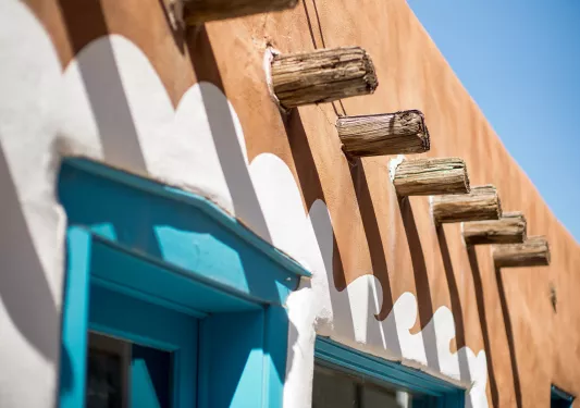 Wooden fixtures on the side of a white and brown building