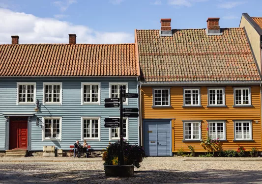Blue and orange houses with sign in front