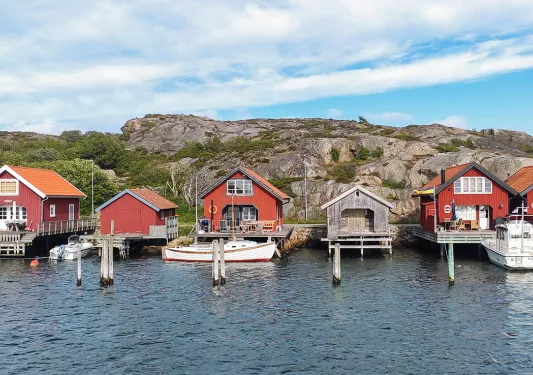 Row of red shacks on a dock by the water
