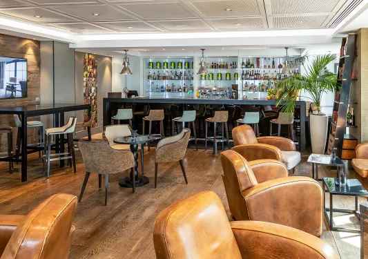 Bar and lounge with a bar counter and alcohol wall in the background