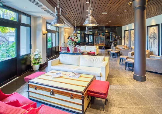 Lounge with cushioned sofas and metal pillars