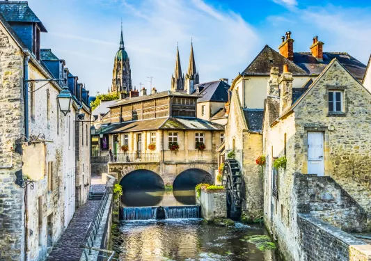 River canal, with stone buildings and a cathedral building in a town