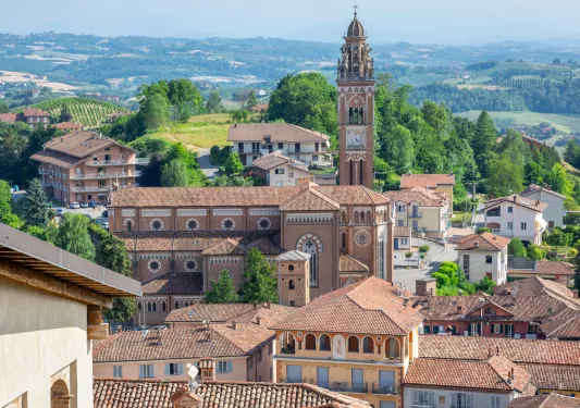 Rustic town with brown building and a large church tower in the center