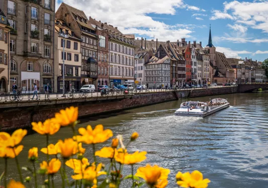 River with a boat and row of buildings to the left