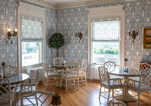 Dining hall room with circular dining tables and white chairs