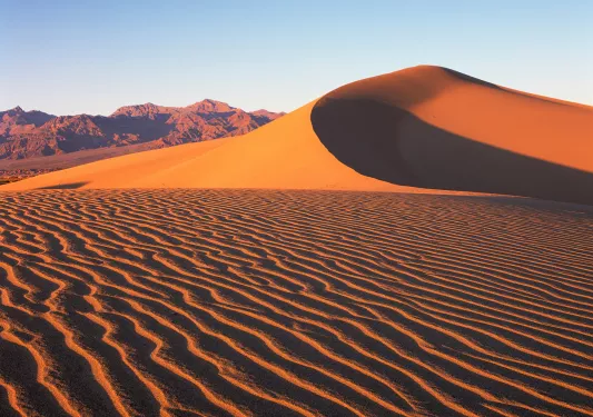 Sand dunes with mountains in the distance