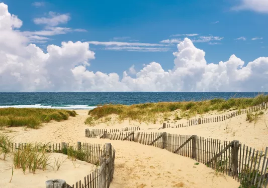 Small pathway of sand leading to the beach