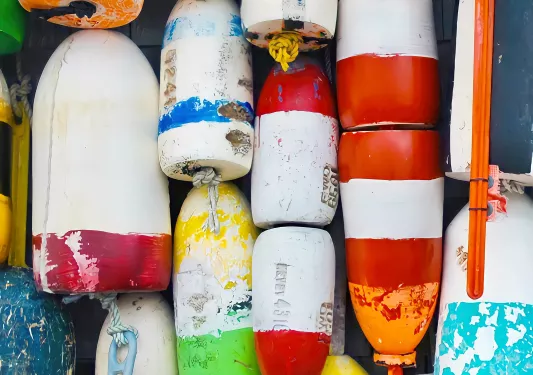 Wall full of buoys  that are discolored