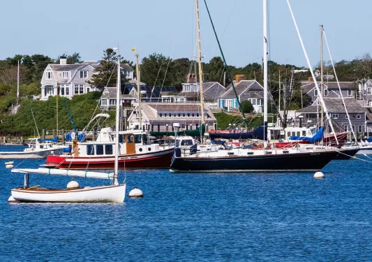 Cluster of boats floating in the water by a dock