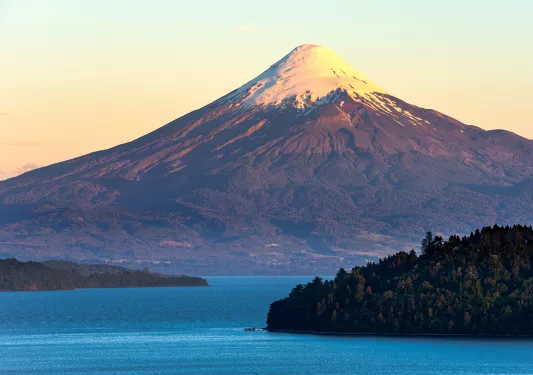 Snow-capped mountain behind a large lake