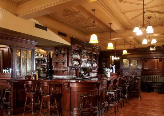 Bar and lounge with wooden stools and counters