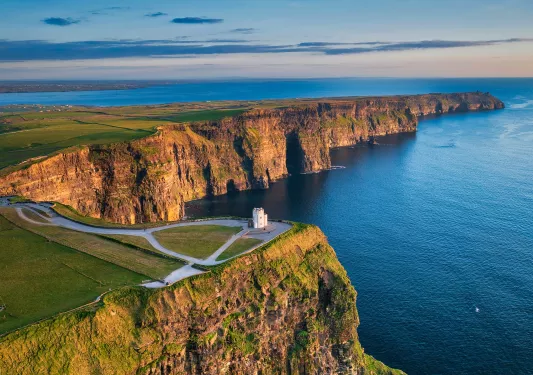 Lighthouse on top of a cliff with the ocean on the ground floor