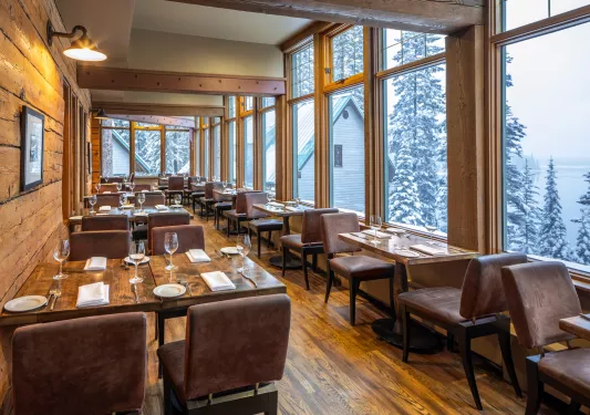 Cabin restaurant with leather chairs and square dining tables