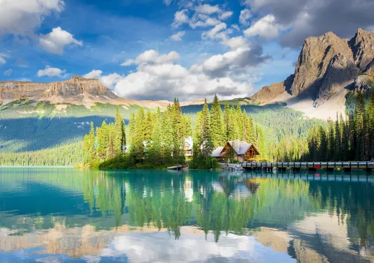 Cabin surrounded by a large lake and tall trees