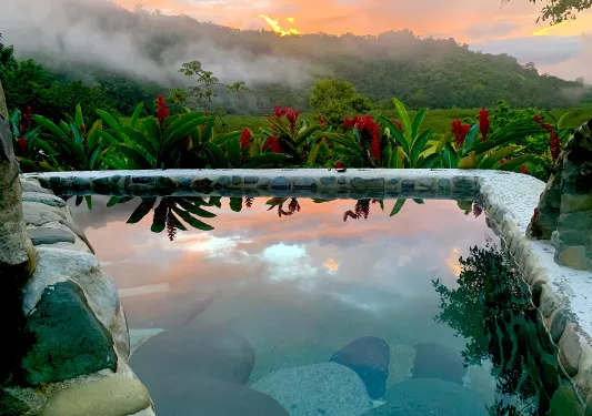 Triangular-shaped outdoor pool, with a valley in the distance