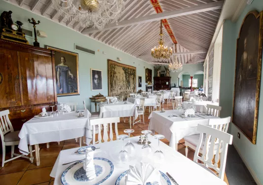 Dining hall with white tables and white and blue plates