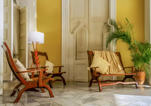 Indoor lobby with three wooden chairs