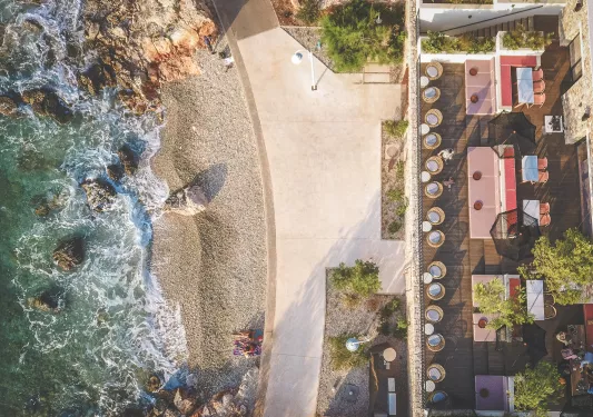 Top view of an outdoor patio, with the beach in front