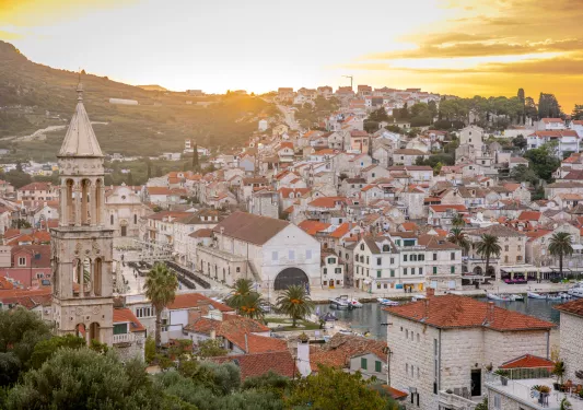 Town with red and beige buildings with a large church tower in the center