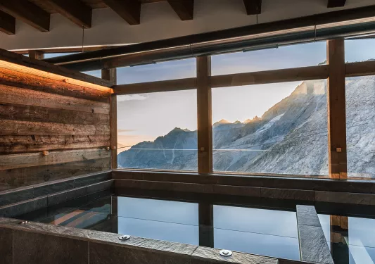 Hot tub spa with a large window looking out to large mountains