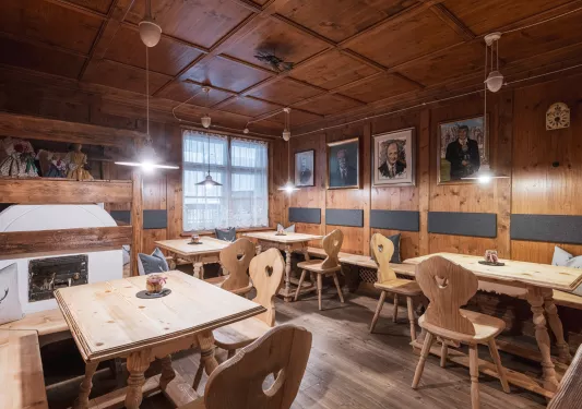 Restaurant dining area with wooden tables and chairs, in a cabin style building