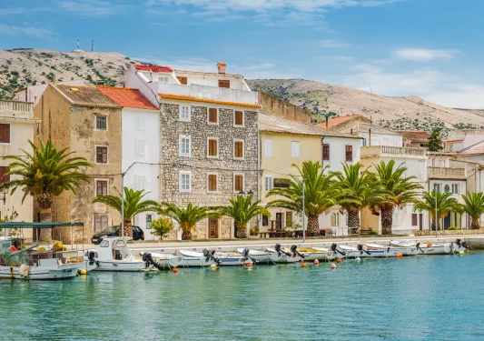 Row of stone and brick houses along a dock by the ocean