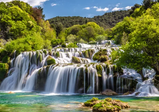 Large waterfall with a forest in the background
