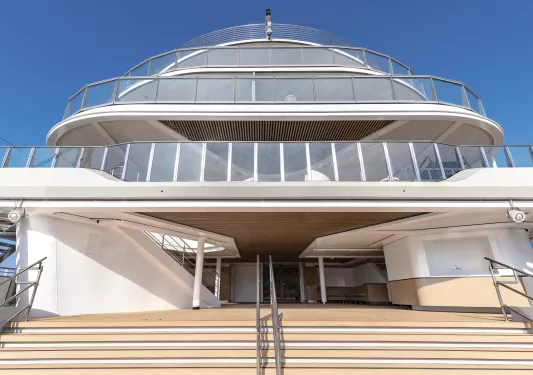 Yacht with a large staircase and three glass balconies on top