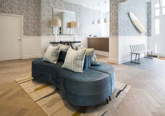 Lobby with a blue sofa and white pillows in the center