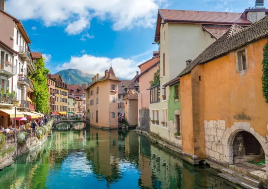 River in a city with crowds of people to the left