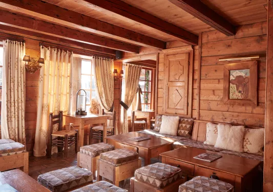 Indoor lounge and seating area inside of a wooden cabin