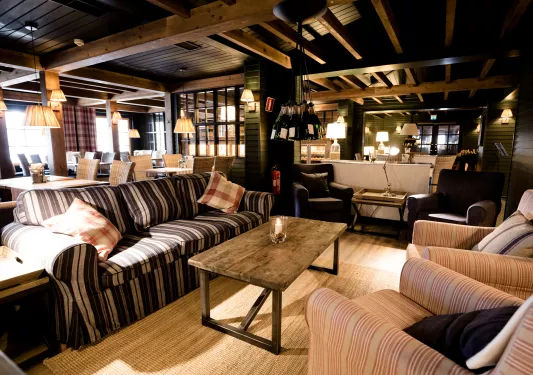 Cafe with cushioned sofas and tables in the background