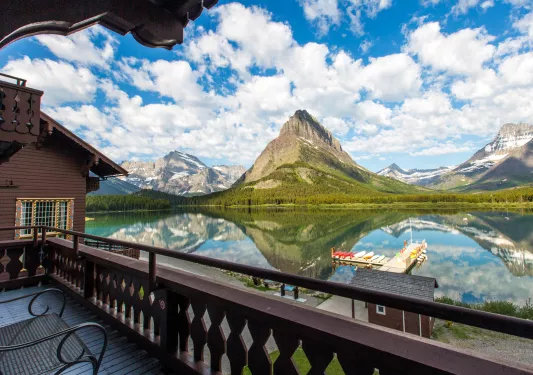 Outdoor balcony with a large lake and mountains in front