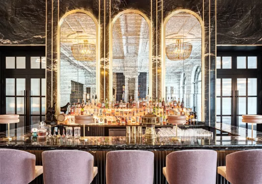 Bar with a marble countertop and alcohol on the shelves