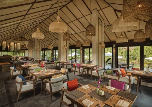 Indoor dining hall with square dining tables and cushioned chairs