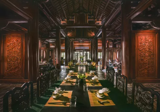 Large dining hall with carved, wooden walls