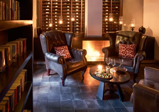 Library with candles and two large, leather chairs