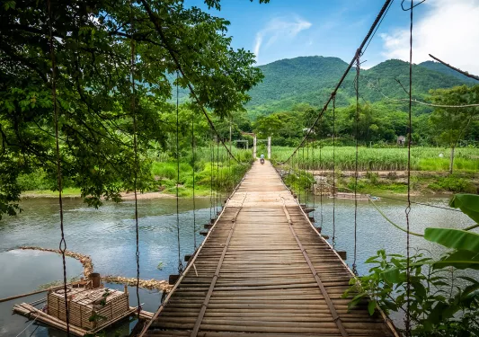 Long wooden bridge over a wide river