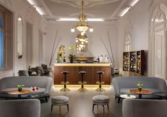 Bar and lounge with gray sofas and black bar stools