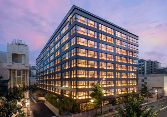 Exterior view of hotel building with illuminated rooms
