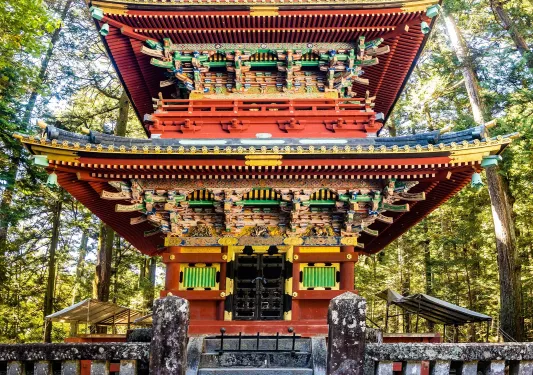 Exterior view of Japanese temple building with a wooden fence in front